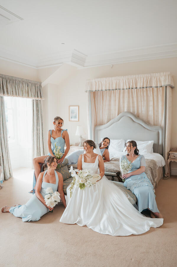 Bride & Bridesmaids Getting Ready Bride sitting with her bridesmaids during relaxed wedding morning preparations at Springkell House.