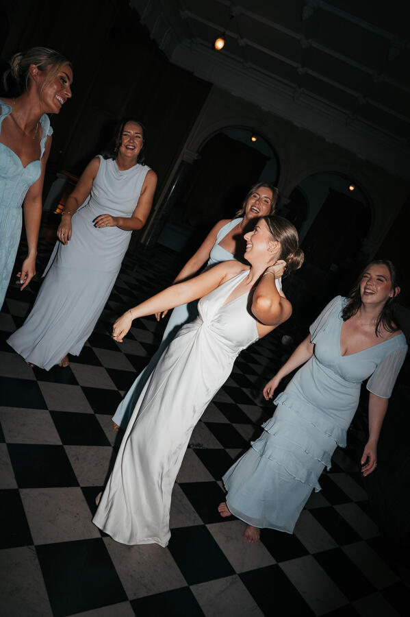 Bride dancing with her bridesmaids during the evening wedding celebrations.