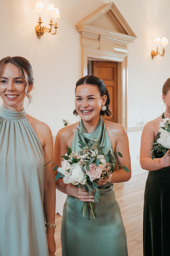 Bridesmaids smiling together with bouquets during an Aberdeenshire wedding day.